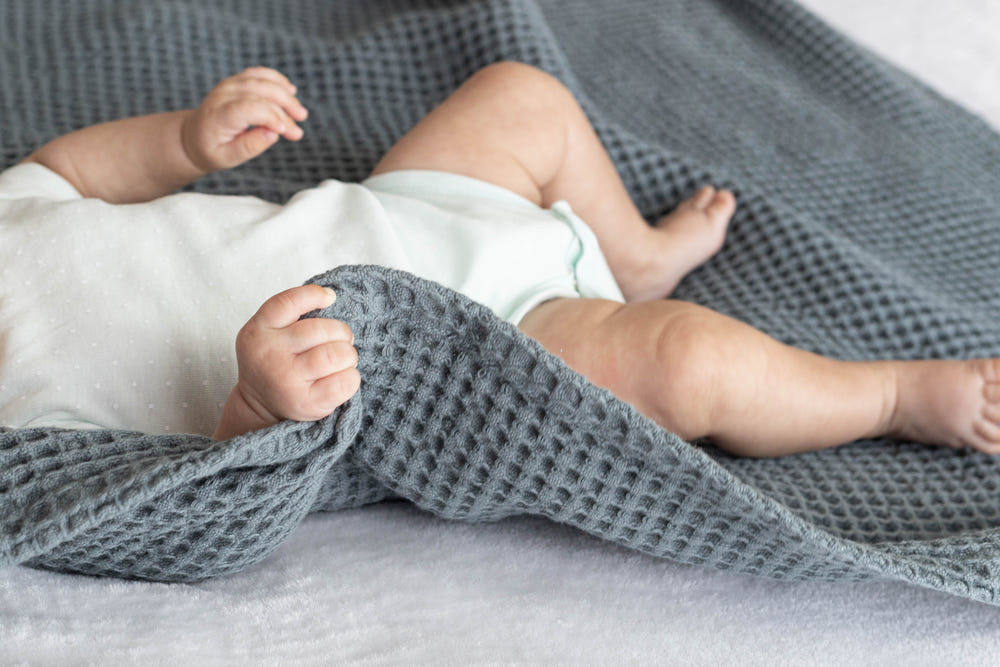Soft waffle baby blanket in pastel colors, perfect for keeping your little one cozy and warm.