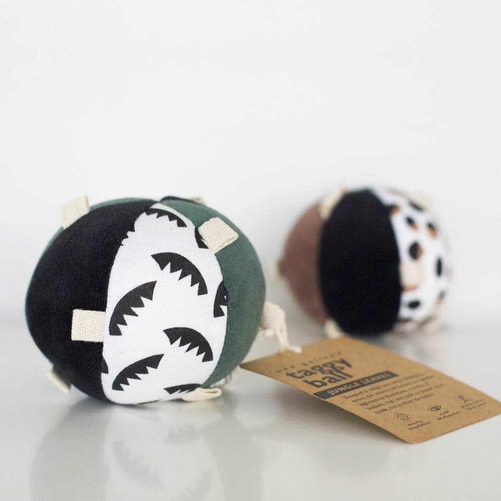 Taggy Ball with Rattle - Jungle Leaves, colorful baby toy for sensory play and development.