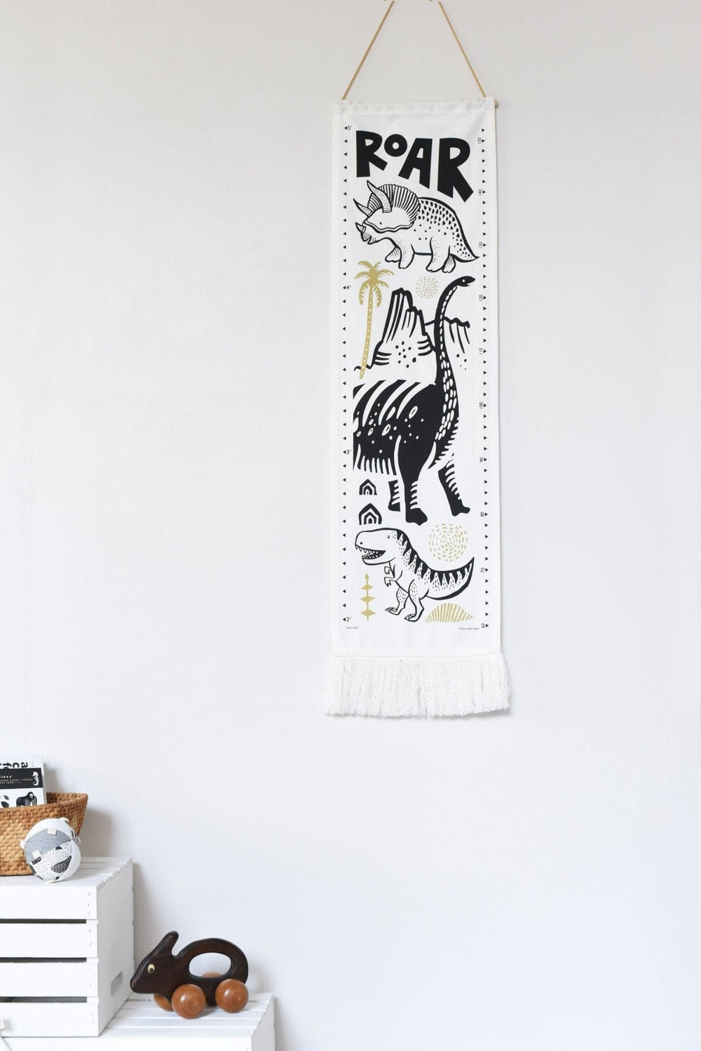 Canvas growth chart featuring colorful dinosaurs, perfect decor for a child's room.