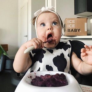 Cowhide Bapron on sale, angle view showcasing stylish design for babies. Perfect for mealtime messes!