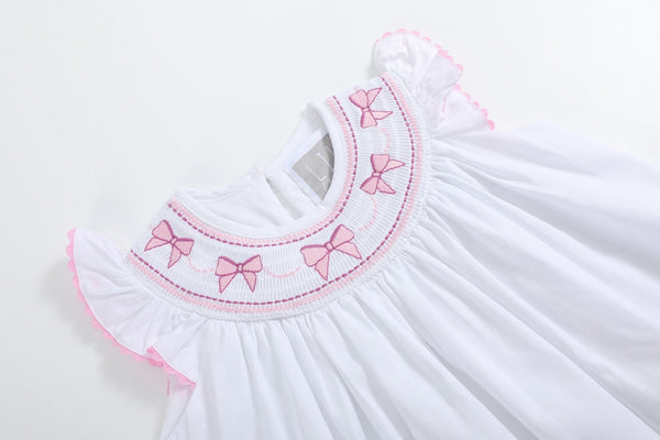 White and pink bows smocked bishop dress for babies, showcased from angle 3.