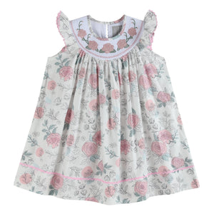 White and pink floral smocked bishop dress for babies, perfect for special occasions and everyday wear.