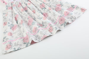 White and pink floral smocked bishop dress for babies, showcasing a charming design from angle 2.