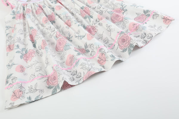 White and pink floral smocked bishop dress for babies, showcasing a charming design from angle 2.