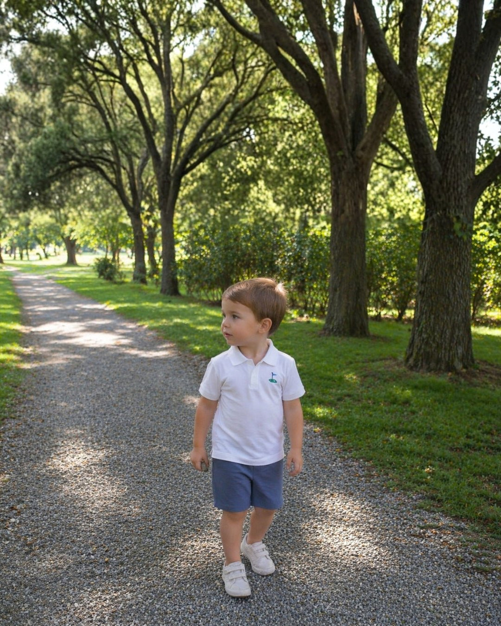 White golf tee polo shirt for babies, perfect for stylish and comfortable playtime.