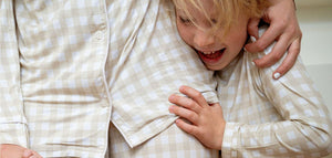 Women's long sleeve gingham pajama set for babies, perfect for cozy sleep and stylish bedding. Angle view.