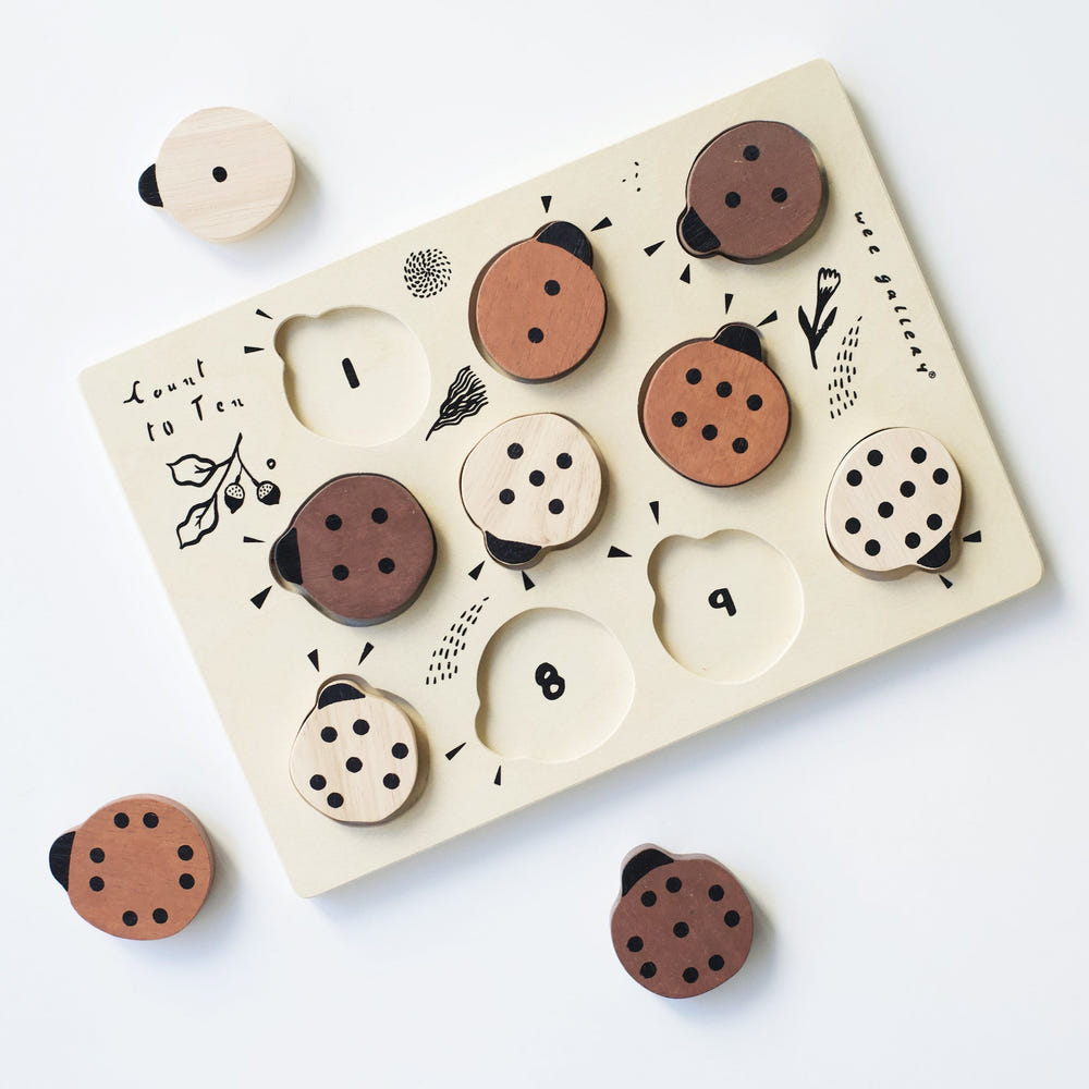 Wooden tray puzzle featuring ladybugs, helping babies learn to count to 10 in a fun and engaging way.