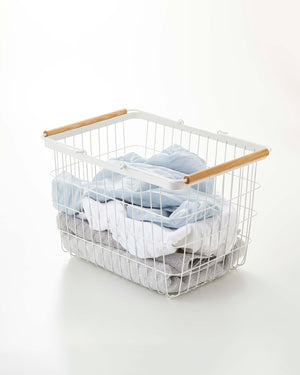 Wire basket set in steel and wood, available in two sizes, perfect for laundry organization.