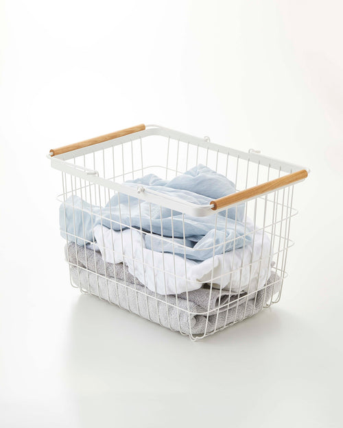 Wire basket set in steel and wood, available in two sizes, perfect for laundry organization.