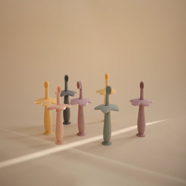 Star Training Toothbrush for babies, angled view showcasing its soft bristles and ergonomic design for easy grip.