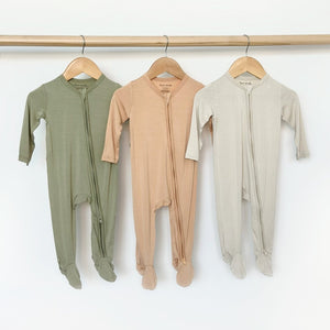 Zippered footie in apricot for babies, perfect for cozy sleep and bedding, shown from angle 3.