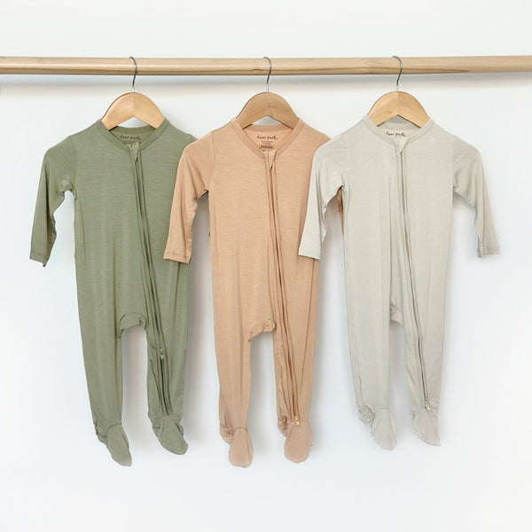 Zippered footie in apricot for babies, perfect for cozy sleep and bedding, shown from angle 3.