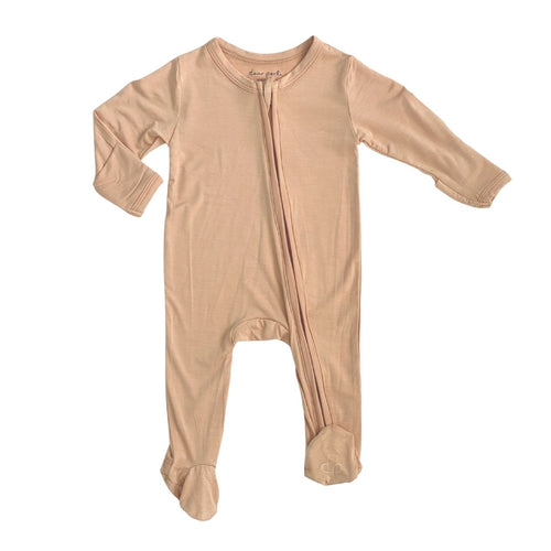 Zippered footie in apricot for babies, perfect for cozy sleep and bedding.
